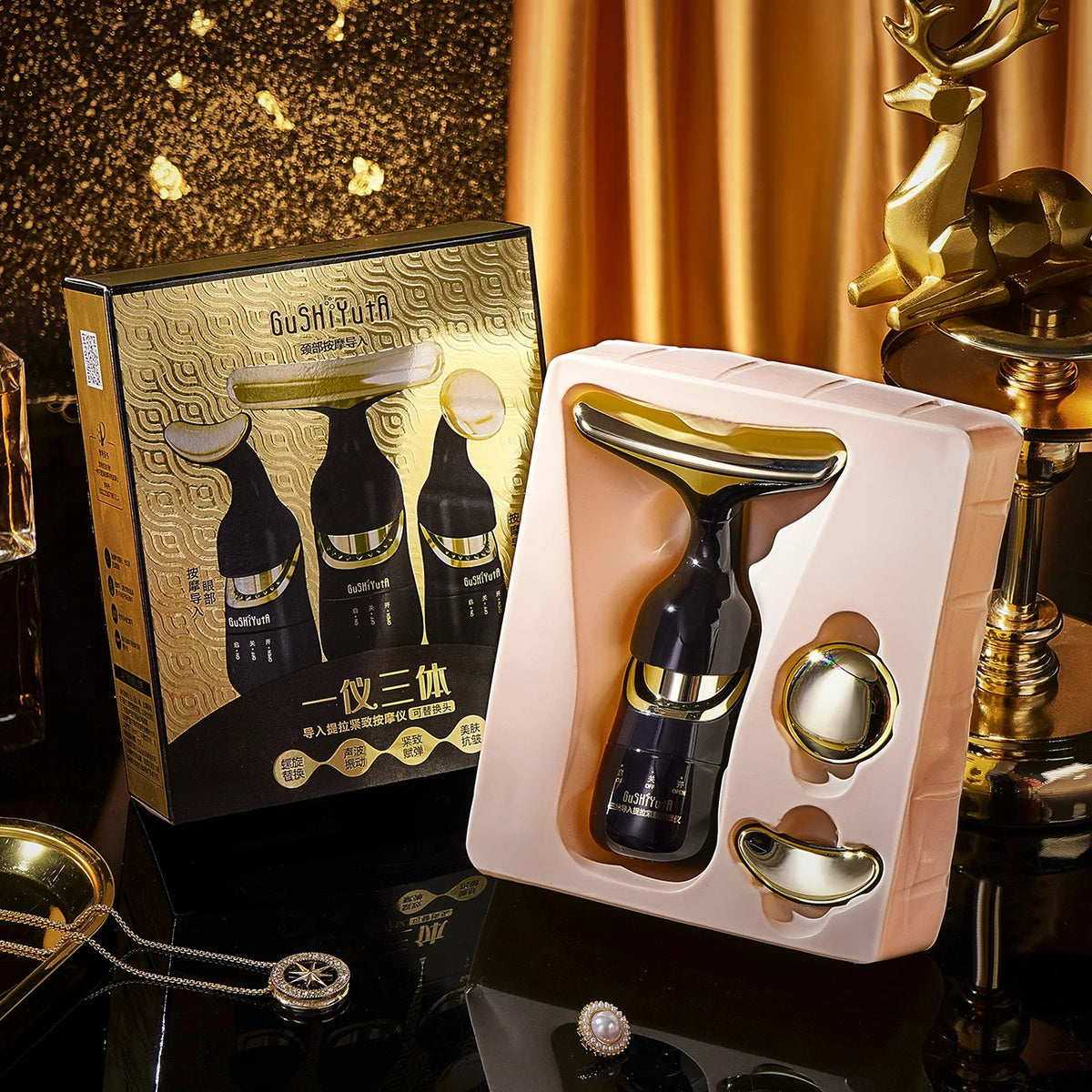 Coffret de massage 3 en 1 noir et or, ouvert dans son écrin, à côté de sa boîte