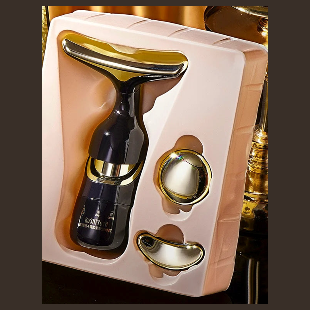 Coffret de massage 3 en 1 ouvert : l'appareil noir et or et ses deux têtes interchangeables dans leur écrin